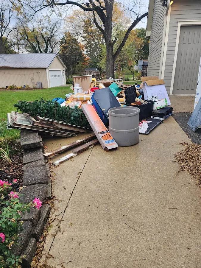 Dumpster being loaded with debris for Roofing Dumpster Rental in Upper Chichester